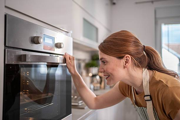istock Woman checking food baking in oven at home 2232677259