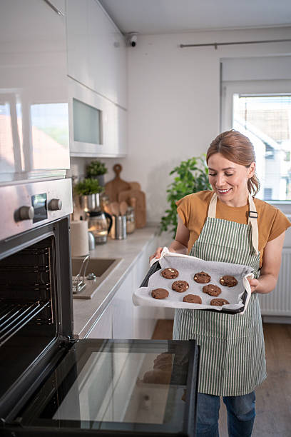 istock Woman baking chocolate chip cookies in modern kitchen 2232677294