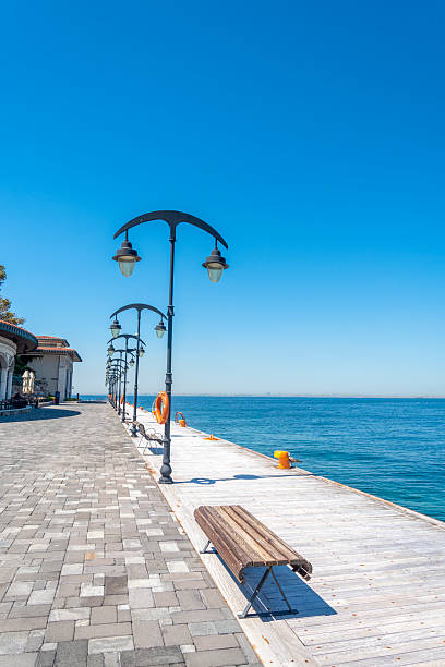 istock Scenic waterfront walkway with bright blue sky and calm waters during the day 2232679856