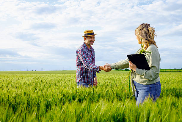 istock Two farmers in wheat field making agreement with handshake. 2232680427