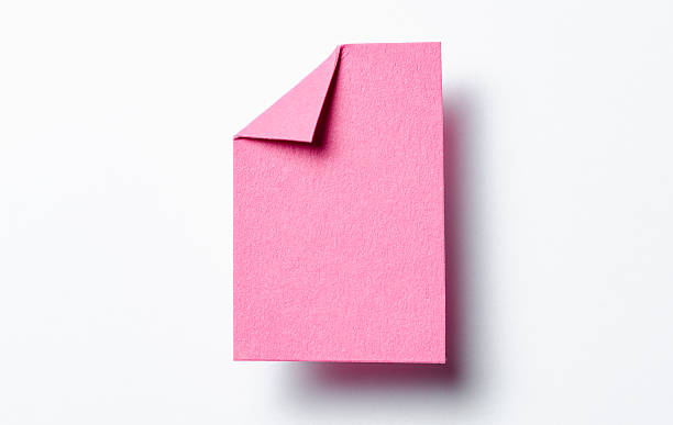 istock Pink paper note cardboard with folded corner dog-ear earmark, drop shadow and copy space for text on white background 2232683073