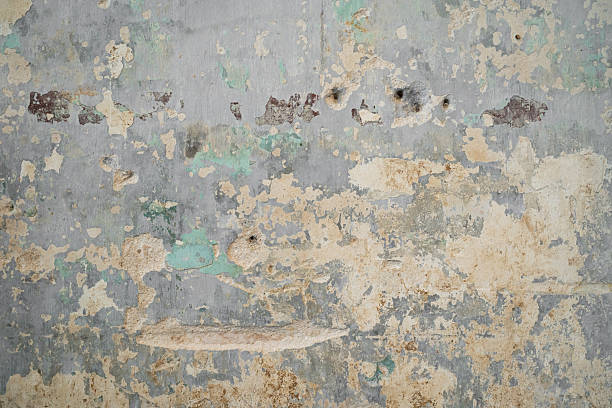 istock A textured wall featuring layers of peeling paint in muted shades, showcasing rustic aesthetics. 2232691170