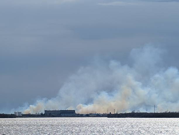 istock Smoke Rising Over Tranquil Water A Chaotic Industrial Scene 2232691913