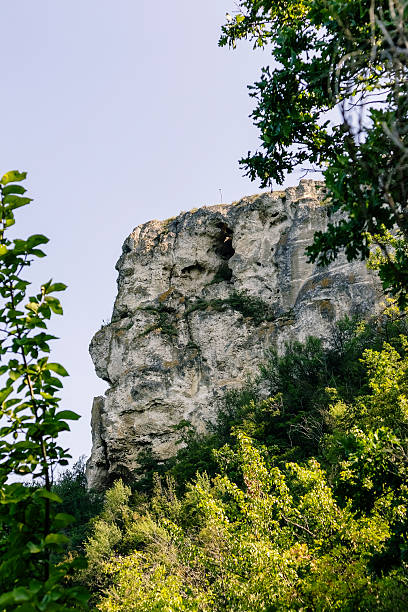 istock Impressive rocky cliffs with green slopes tower over Bakota Bay, Ukraine, symbolizing untouched wilderness and peaceful natural scenery. 2232695122