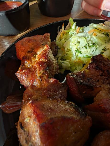 Delicious Grilled Meat with Fresh Salad and Dipping Sauces