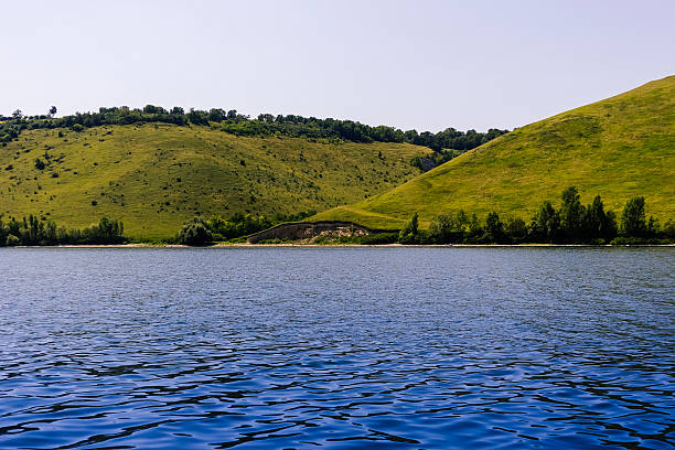 istock Serene landscape featuring tranquil water reflecting lush green hills under a clear sky, capturing the essence of natural beauty and peacefulness. Bakota bay, Dniester river, Ukraine 2232698204
