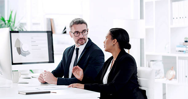 istock Teamwork, advice and business people with graphs for report, consulting and discussion on project. Computer screen, planning and brainstorming with man, woman or manager for proposal review in office 2232700160