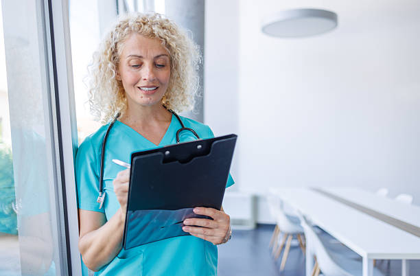 istock Female doctor writing notes on clipboard in hospital 2232700176