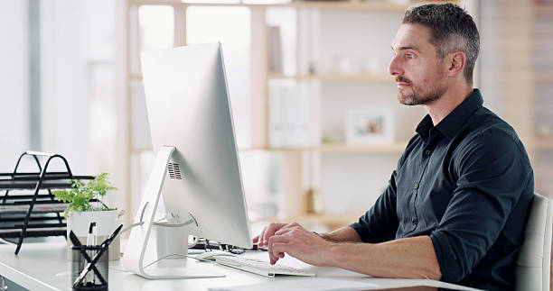 istock Business man, reading or computer in office for company audit, finance reporting or networking. Financial manager, mature person and typing performance email at desk for compliance or risk management 2232700280