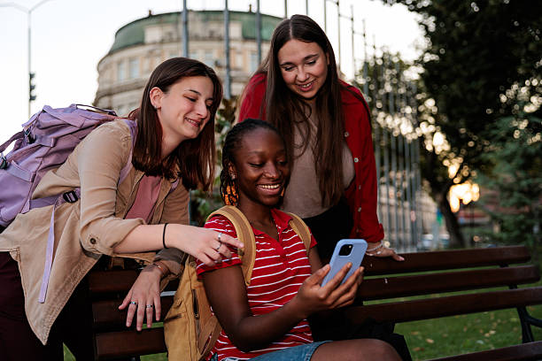 istock Smiling Friends Using a Smartphone in the City 2232701970