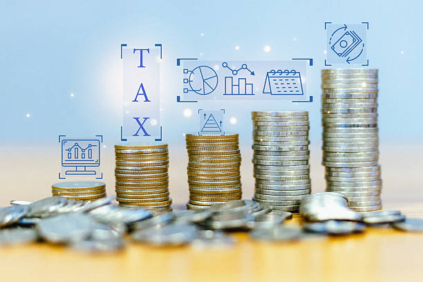 istock A human holds a glowing Earth globe, symbolizing global business and interconnectedness, overlaid with a dynamic upward-trending financial graph, a tax, and a digital coin 2232703499
