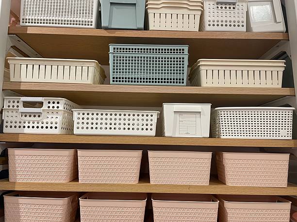 istock Assorted Storage Baskets in White, Blue, and Pink on Wooden Shelves 2232704392