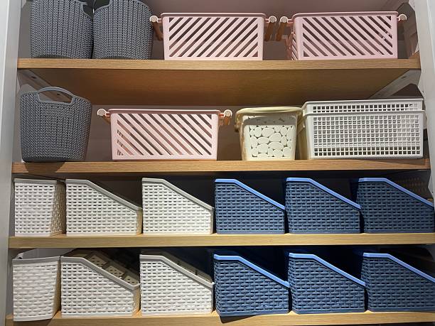 istock Assorted Storage Baskets in White, Blue, and Pink on Wooden Shelves 2232704393