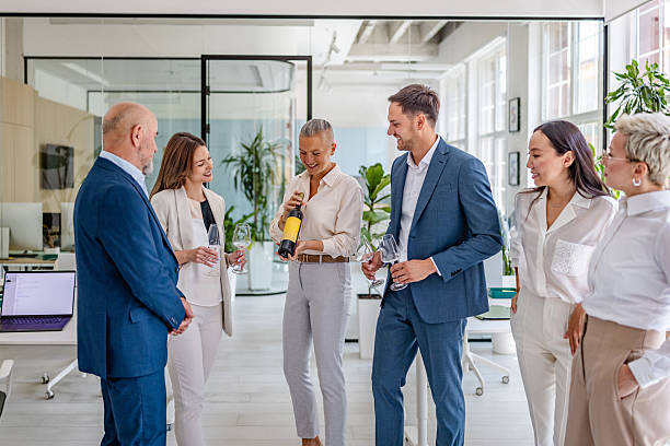 istock Celebration of success with colleagues in a modern office setting during a corporate event with wine 2232704513