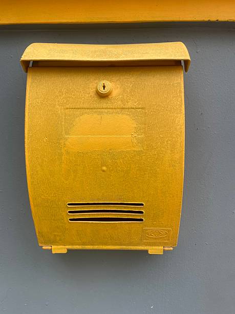 istock Yellow Mailbox on Gray Wall – Outdoor Postal Box 2232705317