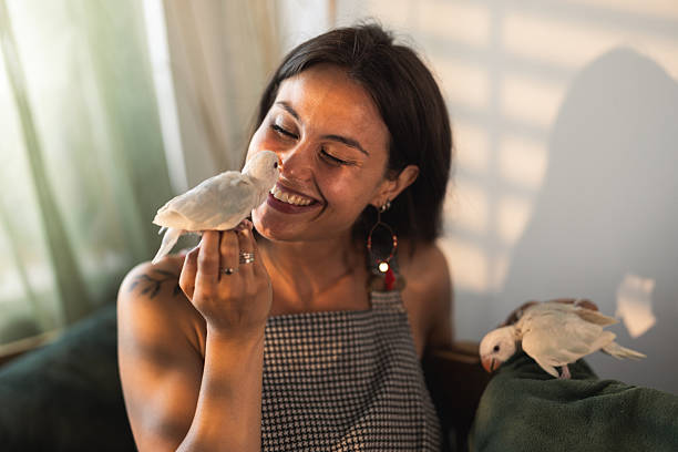 istock Young Woman With Parrots 2232705814