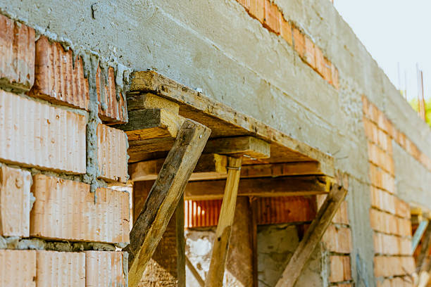 istock house under constraction with modern brick walls and holes for doors and windows. High quality photo 2232708582