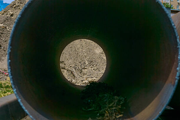 the provision of drainage by sewers.the action or process of draining something