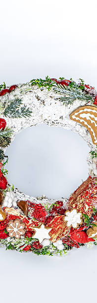 istock Christmas wreath candle candle gingerbread tree white snow isolated 2232711393