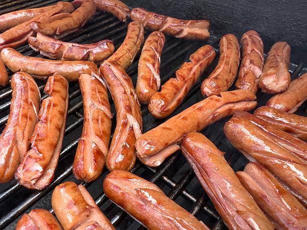 cooking sausages grill on an outdoor