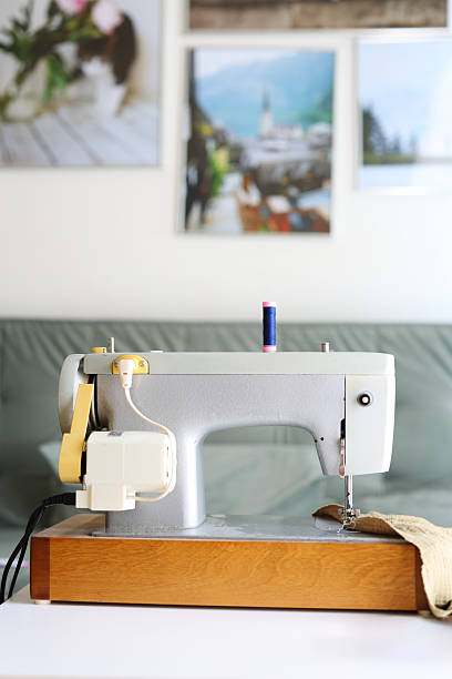 istock Retro sewing machine with spool and tape measure, handmade fashion tool. 2232715599