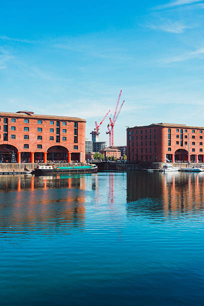 istock Liverpool's royal albert dock reflecting on the water with cranes in background 2232715855