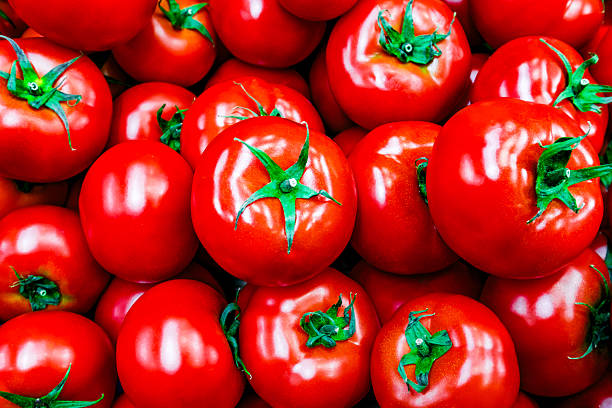 istock red tomatoes in bulk close-up, selective focus 2232718260