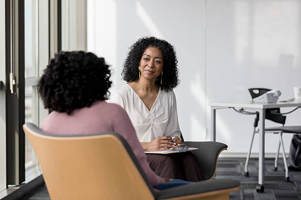 istock Confident therapist listening to patient during counseling session 2232722262