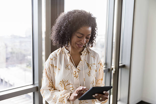 istock Confident Woman Using Digital Tablet Near Window 2232722344