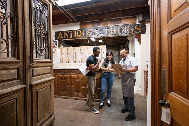 Antique furniture store owner talking to a couple
