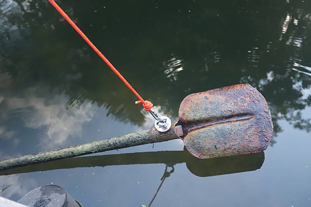 Rusty shovel pulled out of the water during magnet fishing.