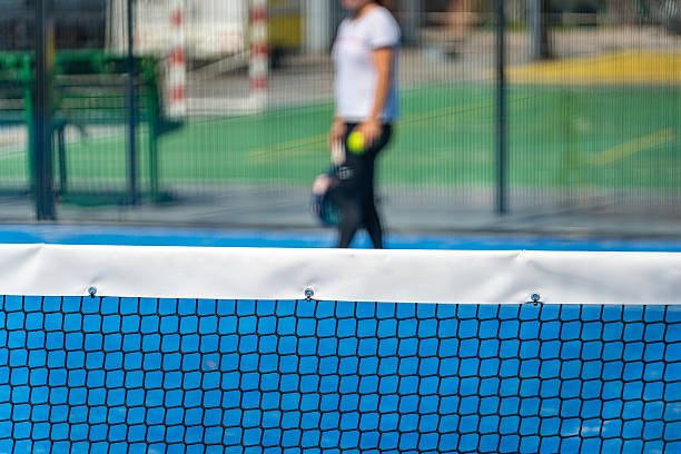 istock Padel tennis net with player walking in background 2232732216