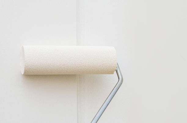 istock Small roller painting wall in white color applying smooth even layer during renovation 2232733580