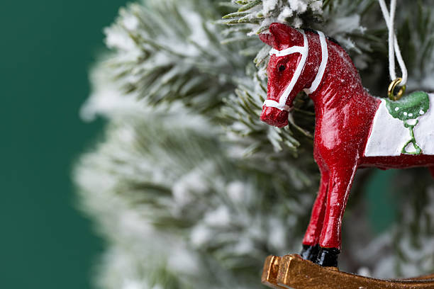 red horse on a Christmas tree with snow