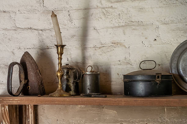 istock An Old candlestick and a pot sitting on a shelf 2232735737