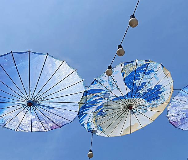 istock Paper umbrellas with graphic 2232736044