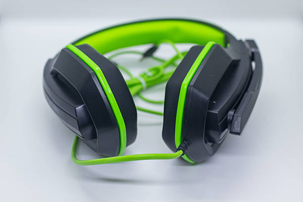 istock Classic music headphones with cable on green. 2232736234