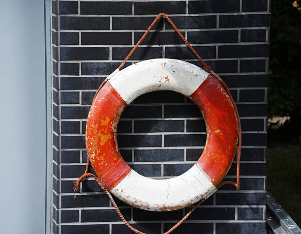 istock Old white-red lifebuoy hanging on the wall as a decorative element 2232736935