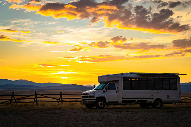 istock RV Camper Parked at a Scenic Valley with Mountains at Sunset 2232736991