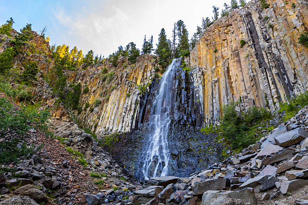 A beautiful view captures the majestic Palisade Falls at sunrise within the Custer Gallatin National Forest