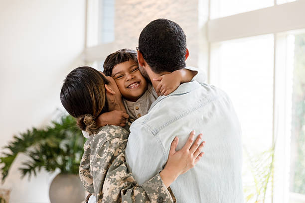 istock Happy Family Reunion: Military Mom, Dad, and Son Embrace 2232737898