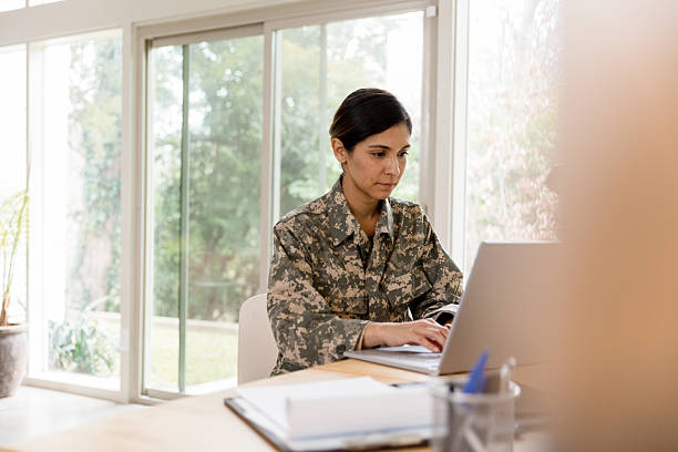 istock Female Soldier Using Laptop, Working from Home Office 2232737912