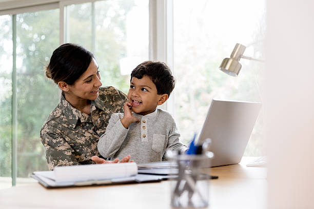 istock Smiling Military Mom and Son Working on Laptop Together 2232737914