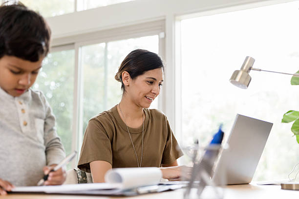 istock Military Mom Working from Home, Using Laptop, Child Studying 2232737926