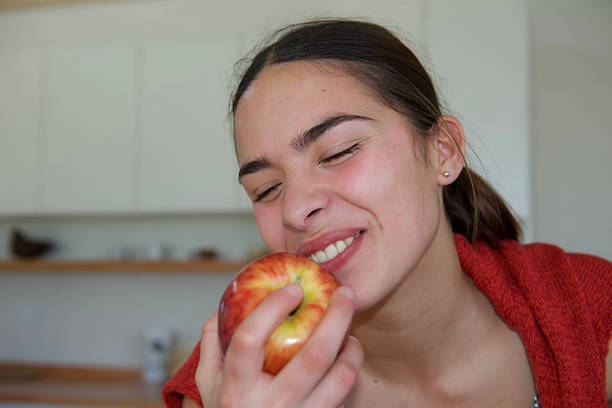 istock girl eating an apple 2232740937