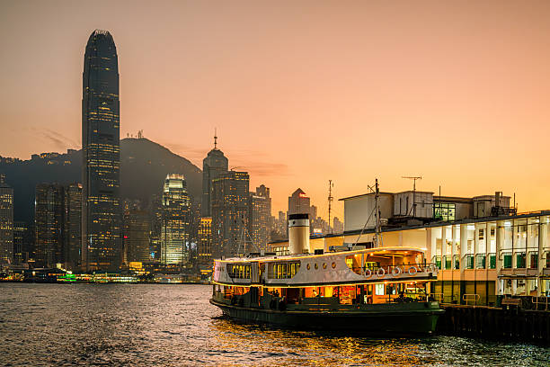 istock Illuminated Skyline and Ferry at Sunset in Hong Kong Harbor 2232749995