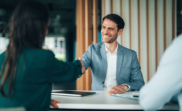 istock Meeting success. Business partners shaking hands 2232750575