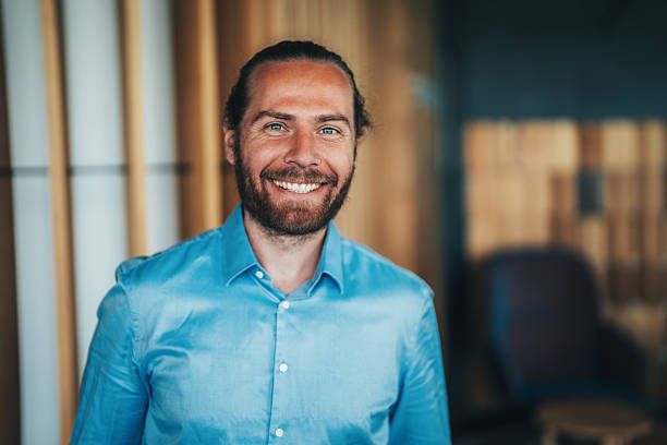 istock Handsome smiling confident businessman in corporate office 2232750581