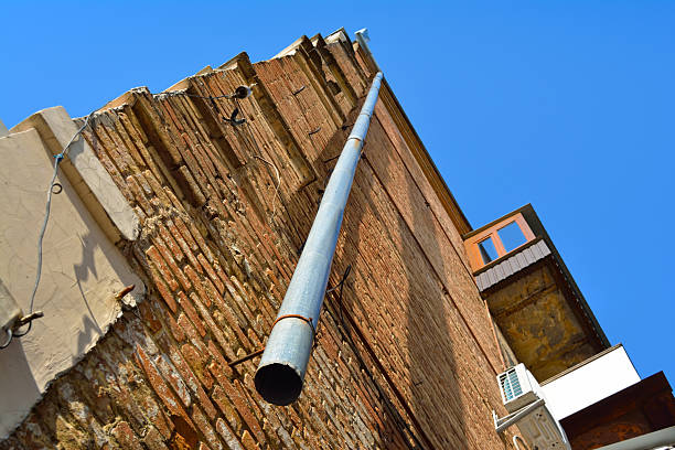 windows in an old building filled in by traditional bricks giving a wall with interesting features