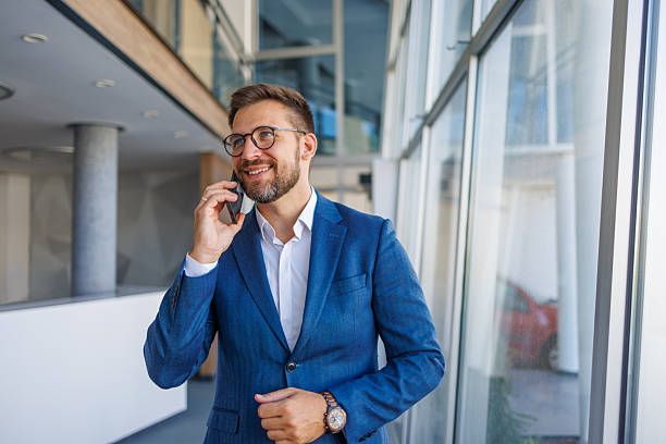 istock Businessman talking on phone in modern office building 2232751743